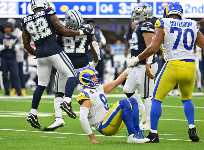 Los Angeles Rams quarterback Matthew Stafford (9) taking a hit from the Dallas Cowboys' Defense.